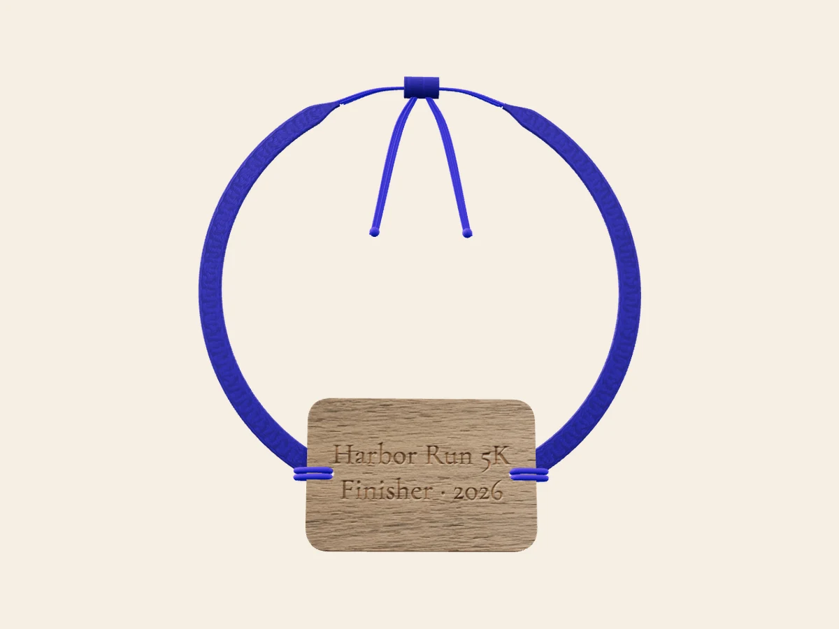 Finisher's Band — No beads — a walnut dog-tag on royal-blue woven cotton. Rendered in the Wearable Events 3D designer.