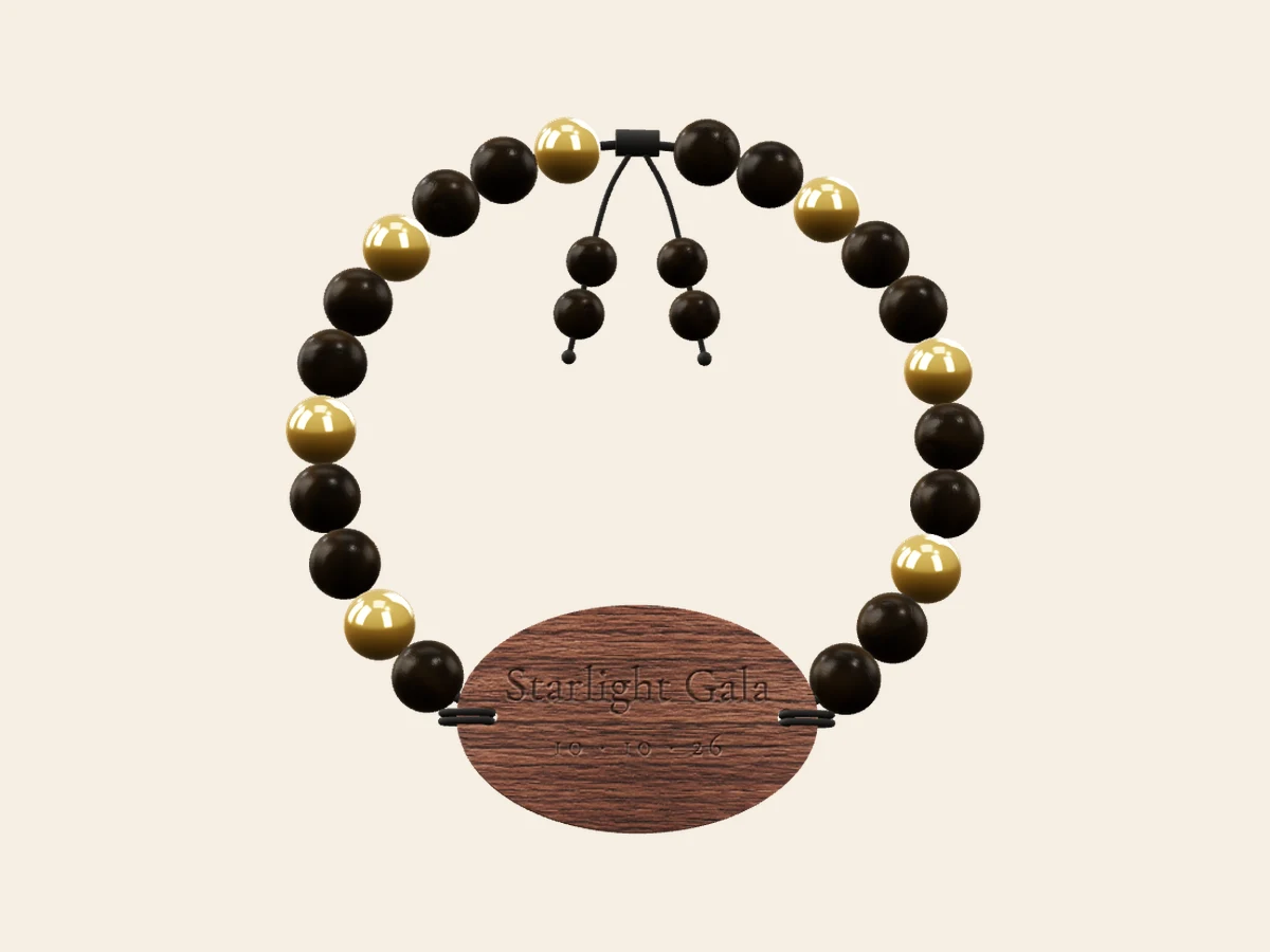Gala Night — Black chacate with warm gold spacers and a rosewood oval tag. Rendered in the Wearable Events 3D designer.