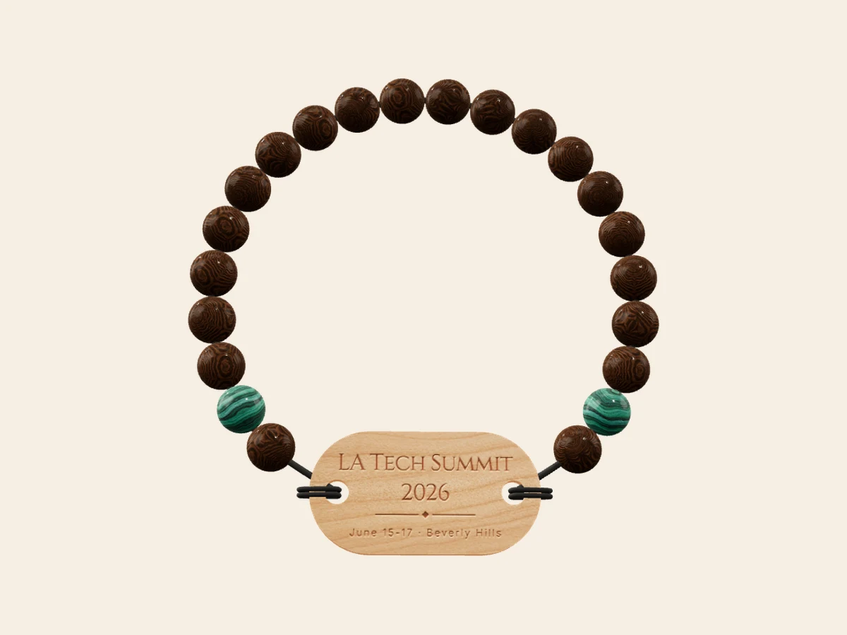 Summit Badge — Abelia wood with malachite accents on a cherry Mini tag — our hero look. Rendered in the Wearable Events 3D designer.
